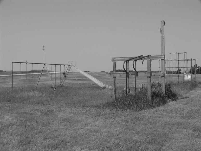 Old playground in Nicodemus Kansas Black and white photograph by Rana Banerjee of a, Nicodemus, Kansas