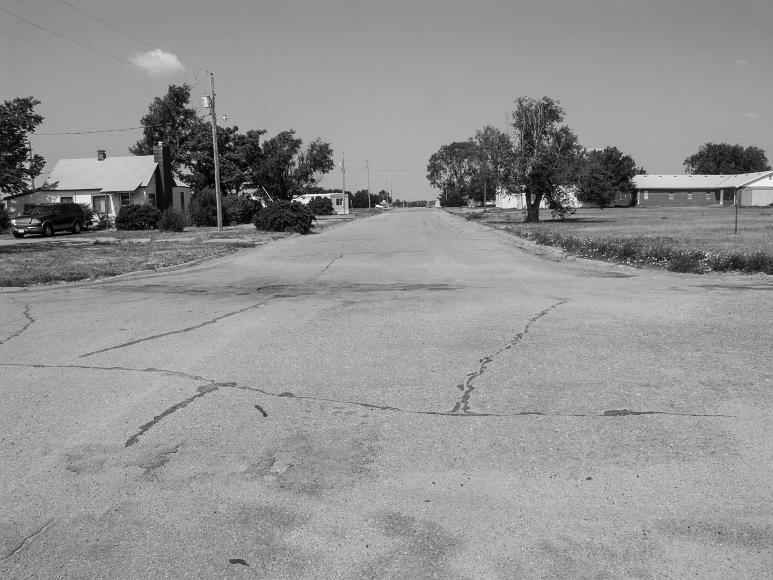 Quiet Street in Nicodemus Kansas Most of the streets in Nicodemus are quiet like this one. It sretches off into the distance past some nonchalant houses, with one SUV visible. Only three tiny...