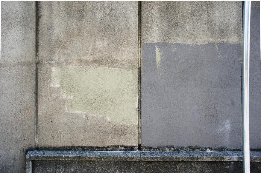 Concrete wall detail Faded concrete wall with structural lines and gray paint over parts and very light green almost to the point of being beige paint over other bits that are...