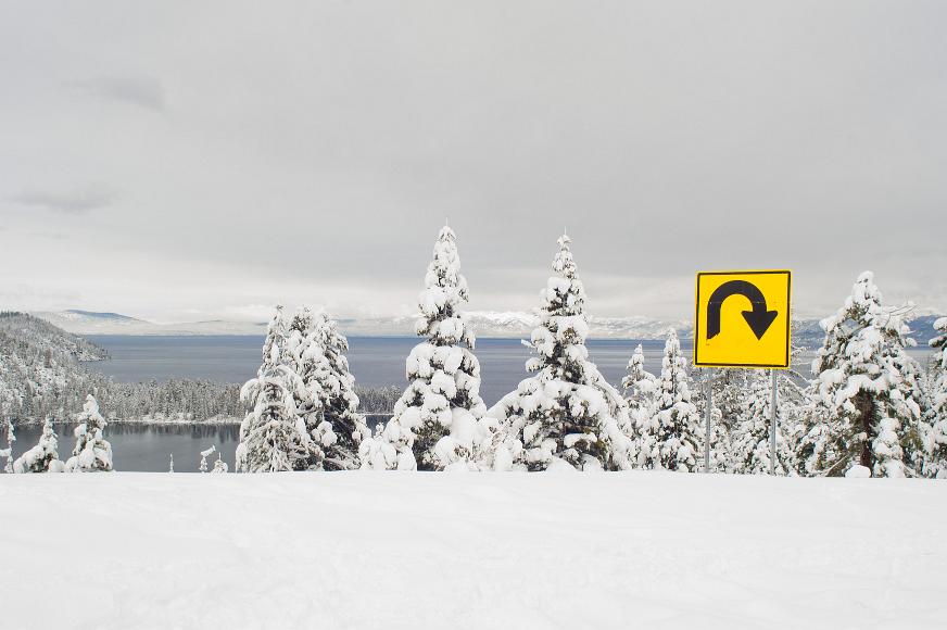 u turn on lake tahoe large yellow and black u turn sign is visible along closed highway 89 at the southwest corner of Lake Tahoe after the first large snowfall of the season with a...