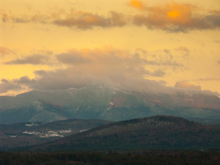 A winter storm clears over Mt Mansfield VT Clouds clearing from a mountain during sunset