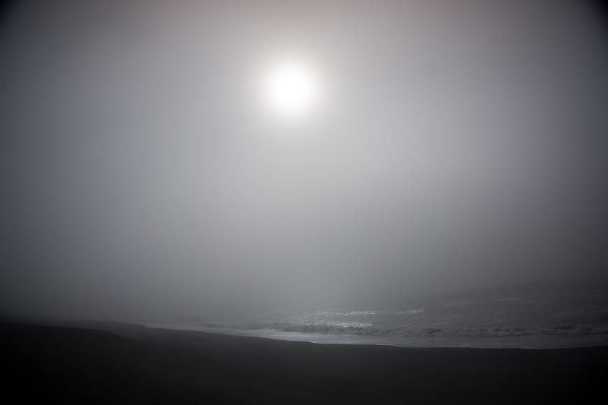Sun Fog Beach Waves sun shining through the fog onto waves crashing on the beach