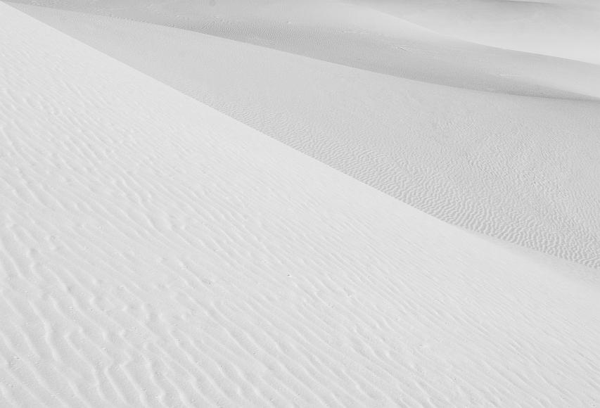 White Sands 2012 15 Black and White gypsum sand dunes underneath with sunlit ripples in the foreground and throughout the images in White Sands National Monument in New Mexico