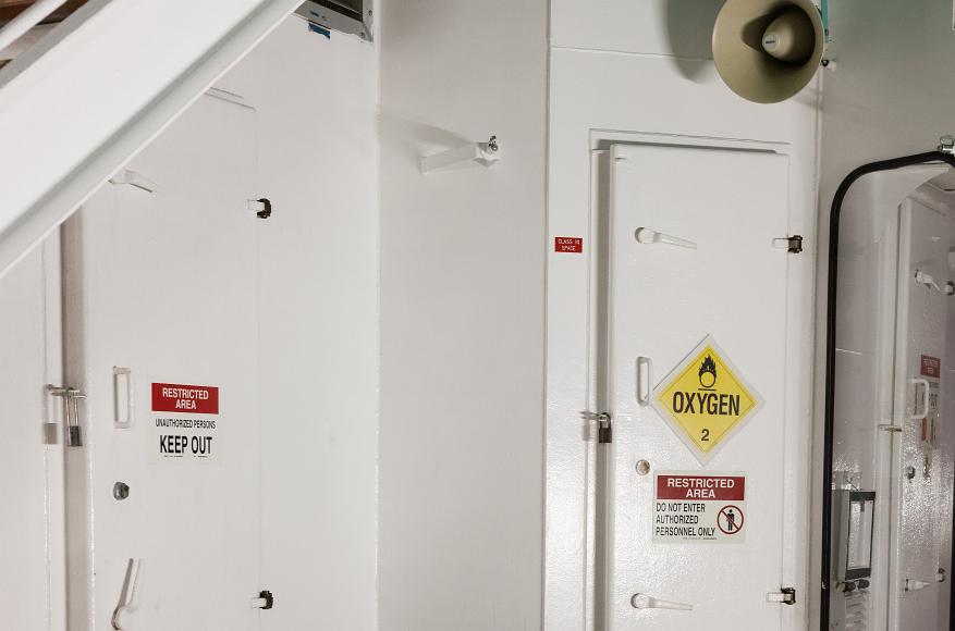 Keep out white doors White metal doors with warning signs on a cruise ship off florida